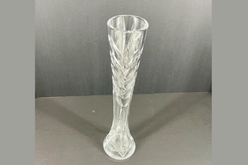 Tall clear crystal vase with a twisted, faceted pattern and a wide base, standing on a gray surface