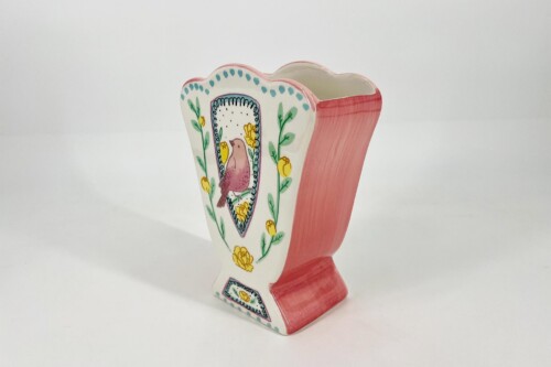 Decorative ceramic vase with a heart-shaped front, pink sides, and a floral bird design on the front panel.