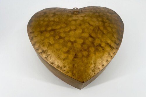 Heart-shaped wooden jewelry box with a warm gold finish and a small metal clasp on the lid