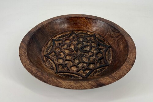 Round wooden bowl with a dark, rich finish and a detailed carved lattice centerpiece inside.