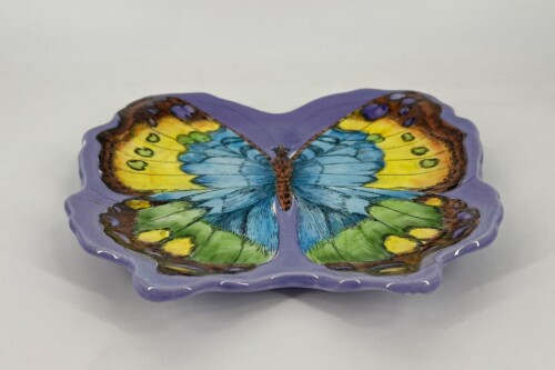 Purple butterfly-shaped ceramic dish with multicolored wings for decorative display