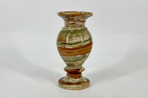 Multicolored striped ceramic vase with a narrow neck and rounded body, standing on a small circular base