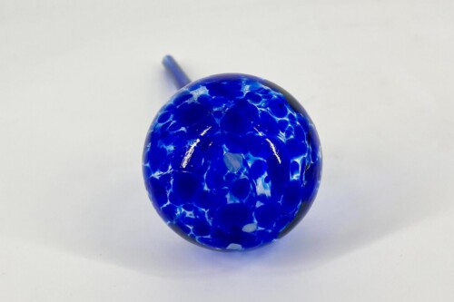Blue glass marble with white swirled pattern on a white background, close-up view.
