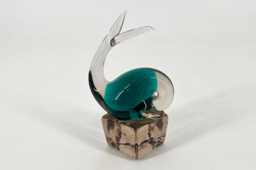 Glass sculpture of a graceful swan with a curved neck, teal body, and clear glass accents on a brown, faceted base.
