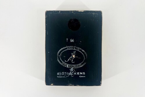 Vintage dark blue wooden box with a circular embossed seal on its front and weathered edges. The box has faded white text and a small handwritten mark '66' above the seal, suggesting age or a catalog number.