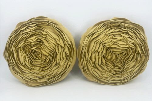 Two beige, circular paper sculptures formed from many layered curls placed side by side on a white background.