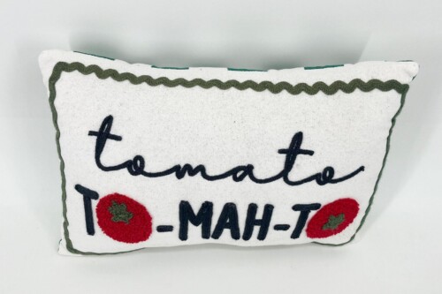 White fabric decorative pillow with green zigzag edging and embroidered red tomatoes around black cursive text; a cozy kitchen/room decor item.