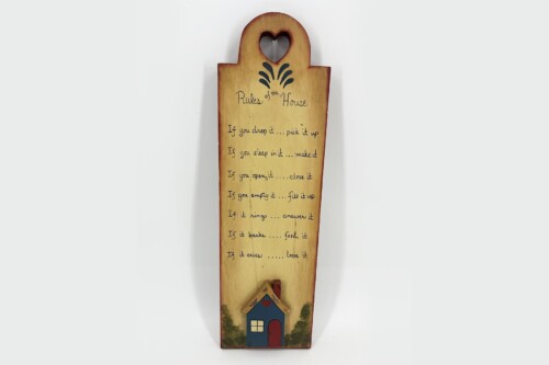 Wooden house-shaped sign titled 'Rules of the House' with a heart cutout, listing home rules in handwriting-style text on a light wood background.