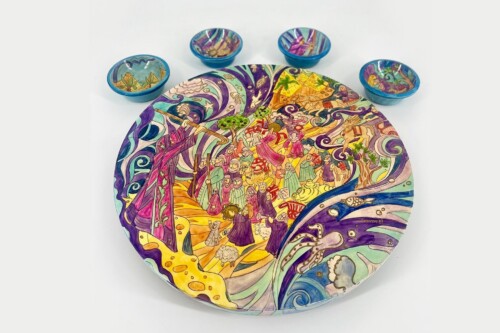 Large round plate with a vibrant, whimsical scene of people dancing among swirls; four small blue bowls behind it.