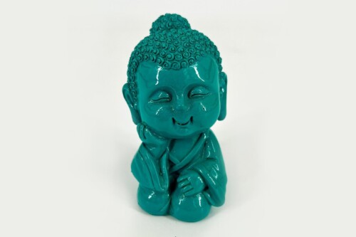 Turquoise ceramic Buddha statue with hands pressed together in a prayer pose, smiling.
