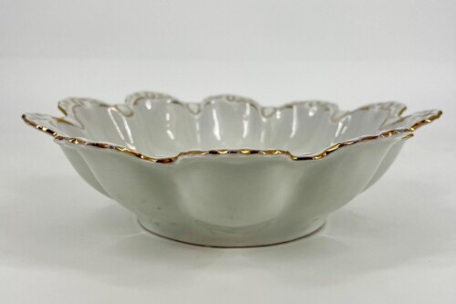 White porcelain bowl with a scalloped, wavy edge and gold trim along the rim; shallow serving dish for decorative use.