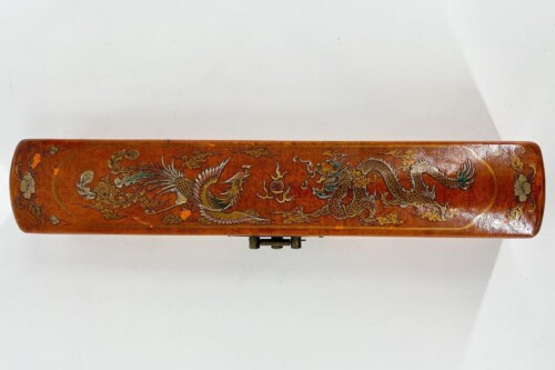 Long brown leather case decorated with a detailed dragon and cloud motif along its length.