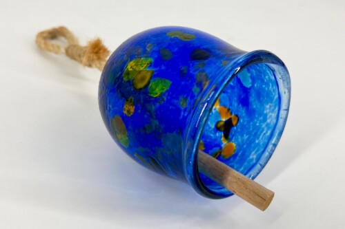 Blue glass bell ornament with green-yellow speckles, hanging rope, and a wooden dowel inside.