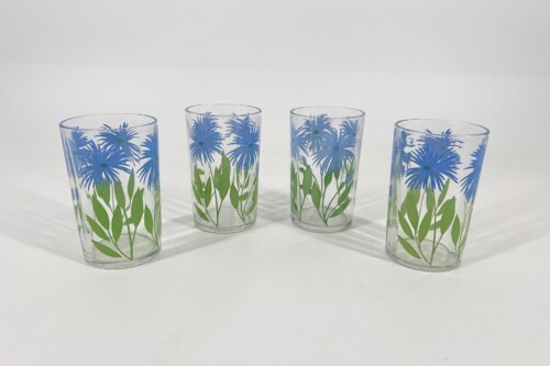 Four clear tumblers with a blue floral pattern and green stems, arranged in a row on a white surface.