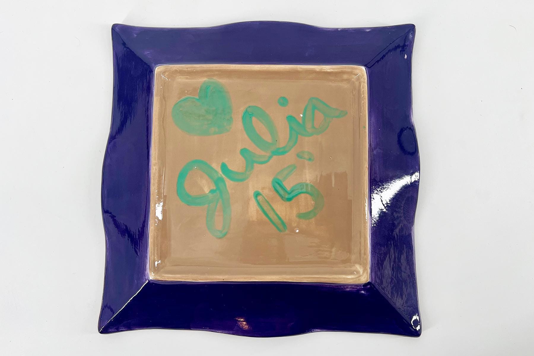 Ceramic square plate with a purple border and beige center, featuring teal handwritten 'good job'.