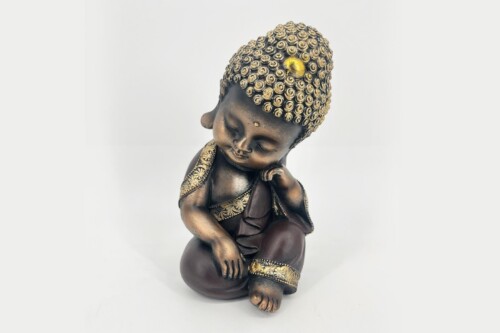 Bronze Buddha baby statue with curly hair and gold accents, seated in a peaceful pose with eyes closed.