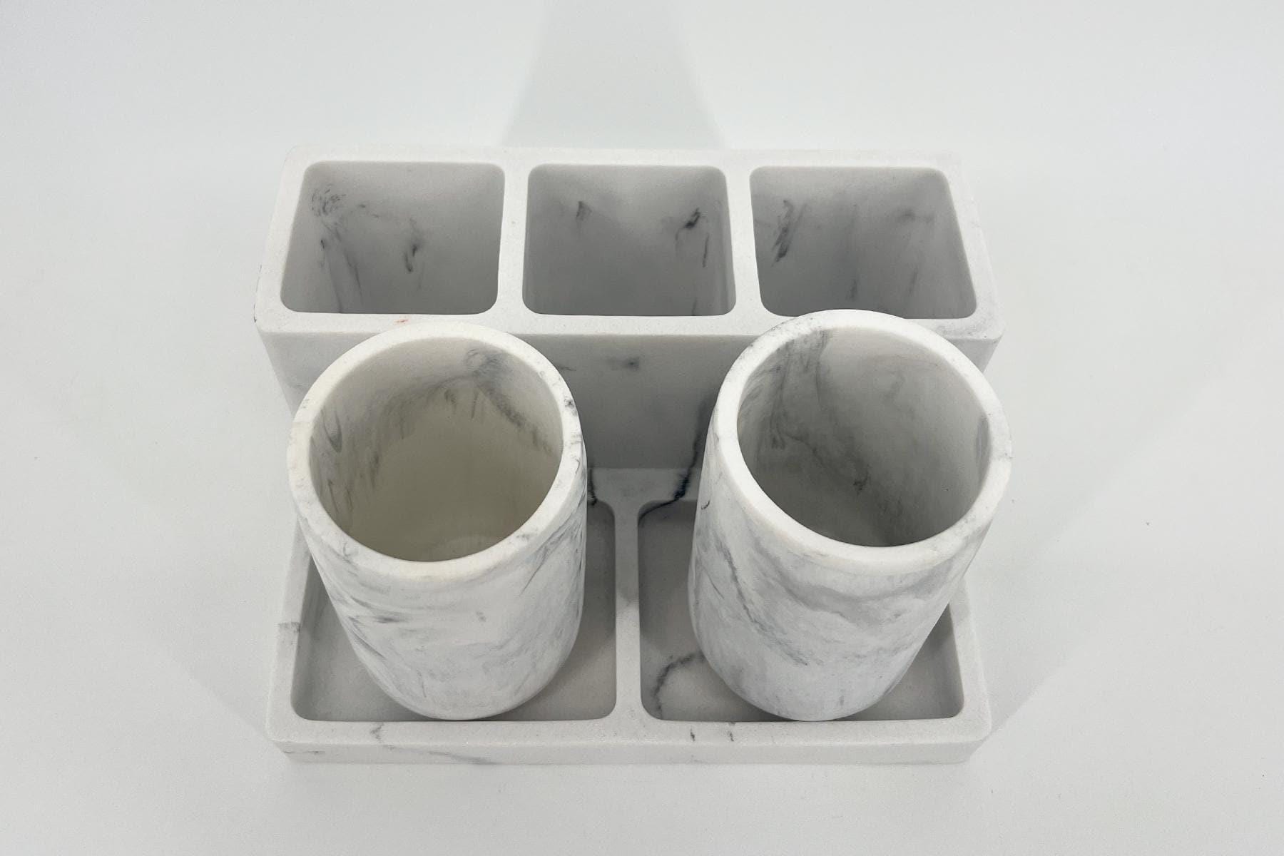 White marble-patterned concrete organizer with three rectangular slots on top and two cylindrical tubes below.