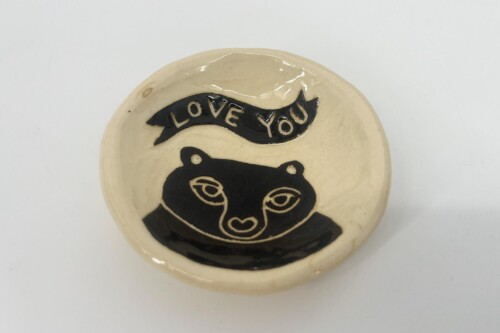 Decorative ceramic round plate with a black panda face and a curved banner that says “LOVE YOU.”