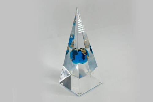 Crystal pyramid award with blue globes inside, resting on a clear base.