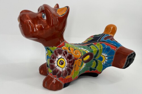 Colorful ceramic dog sculpture with a floral pattern and glossy glaze, decorative piece