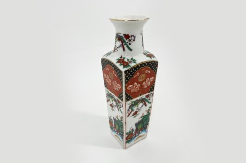 Tall white porcelain vase with red, green, and gold floral panels and a gold rim on the rim and shoulder area.