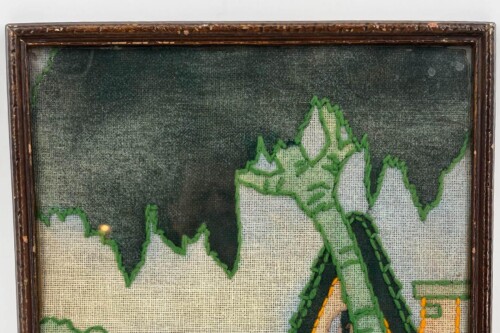 Framed textile art showing green-embroidered mountain peaks on beige burlap with a dark gradient background