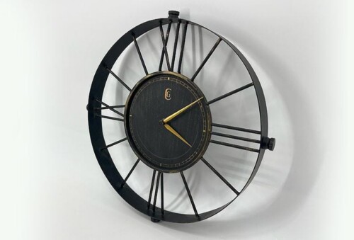 Open-frame wall clock with black metal spokes and a dark center, gold hour and minute hands.