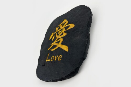 Dark slate stone with gold Chinese character for 'love' and the word 'Love' embossed beneath it