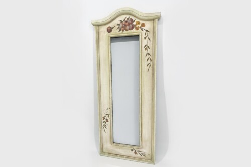 Tall, vintage cream-colored wooden mirror with a floral hand-painted design along the frame and a curved top edge, hung against a light wall.