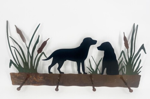 Rust-colored metal wall sculpture with two dogs facing each other among tall grasses on a rusted shelf.