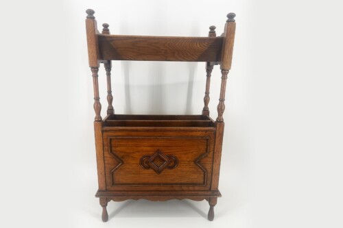 Antique wooden washstand with a carved front panel and turned legs, shown in a vertical view