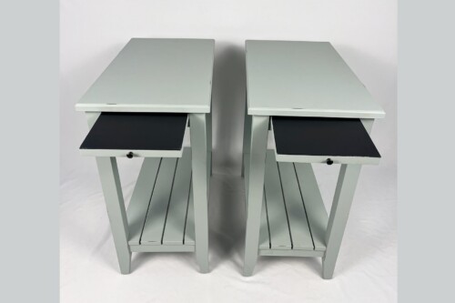 Pair of pale gray-green end tables with black interior drawers pulled open slightly.