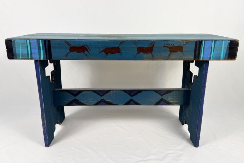 Blue wooden bench with brown horse silhouettes along the side and teal striped accents on the ends (rustic, painted furniture).