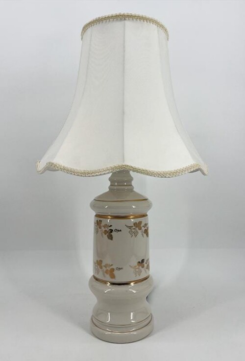 Cream ceramic table lamp with a gold floral pattern and a white fabric lampshade.