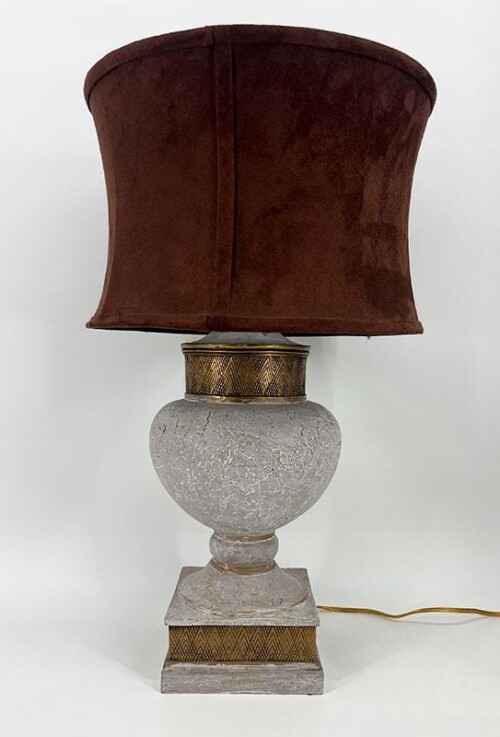 Gray marble-like table lamp with a large brown fabric shade and brass accents, cord visible on the base.