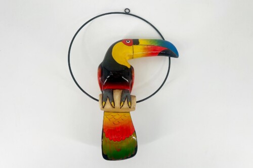 Colorful wooden toucan sculpture with a rainbow beak, hanging from a black circular hoop against a white background.