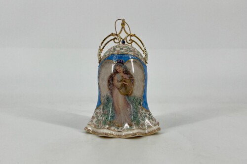 Porcelain figurine of a woman in a flowing dress holding a lyre, with blue trim and floral details, topped by a gold ornate crown-like structure.