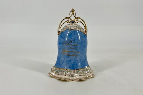 Decorative porcelain vase with blue glaze, floral trim, and an ornate gold crown lid.