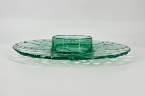 Teal glass plate with a raised central ring, set on a light background.