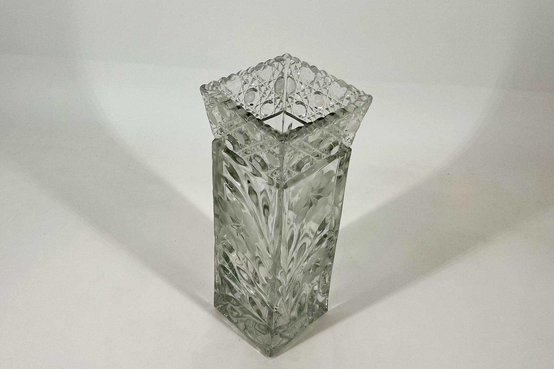 Crystal cut-glass square vase with an ornate faceted rim, empty on a white surface.