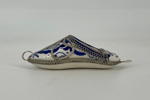 Decorative porcelain slipper with cobalt blue floral pattern and ornate silver filigree trim and hoops throughout the shoe edge.