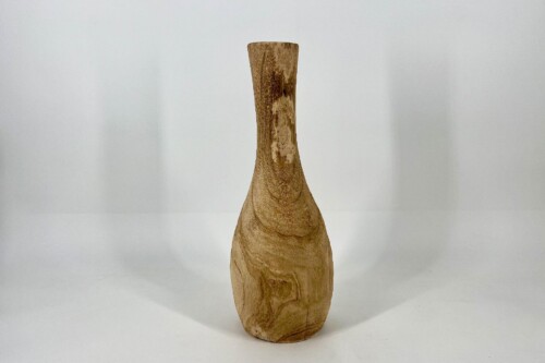 Wooden carved bottle-shaped sculpture with a tall, narrow neck on a white background.