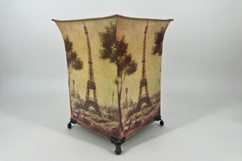 Decorative parlor lamp with Eiffel Tower print on a beige, curved shade and ornate metal legs.