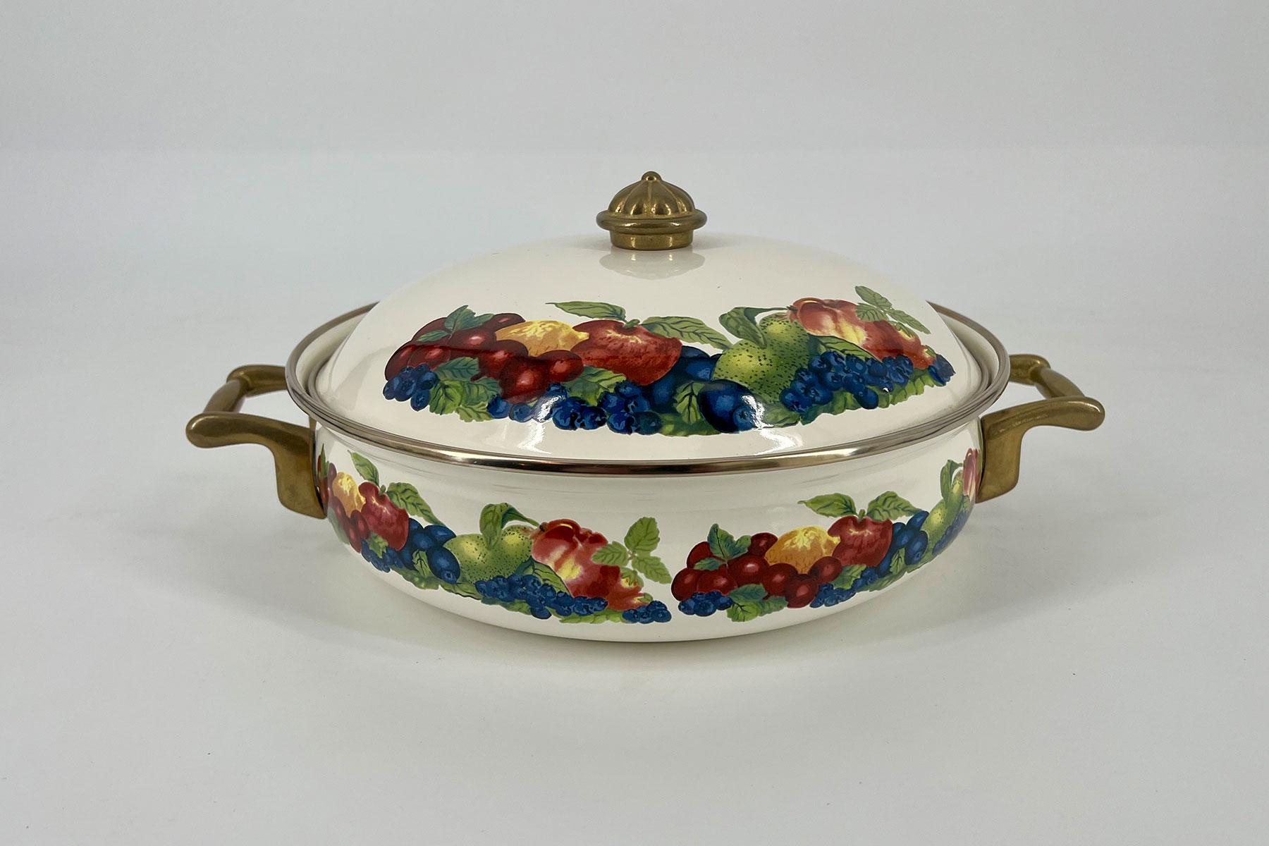 White ceramic tureen with brass handles and floral fruit motif (grapes, berries, and apples) on lid and body, decorative kitchenware.