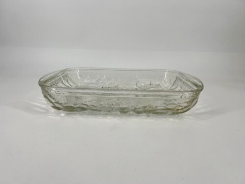 Rectangular clear glass baking dish with an etched rim, empty on a white surface