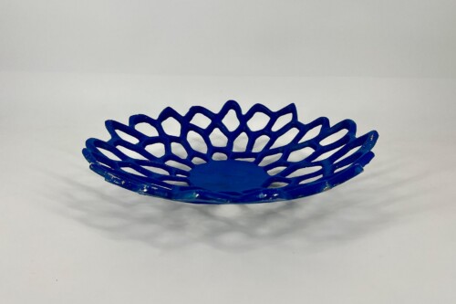 Blue open-weave decorative bowl with a lattice pattern on a white surface