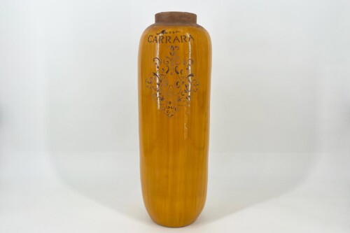 Tall amber-colored vase with a brown rim and an ornate brown decorative motif on the front.