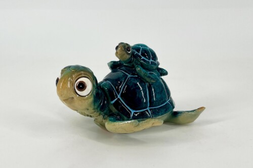 Glazed ceramic turtle with a tiny turtle perched on its shell (decorative sculpture).