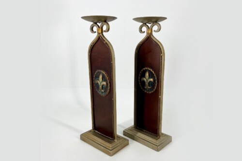 Pair of ornate vintage candlesticks with fleur-de-lismedallions and brown leather panels in brass frames, standing on rectangular bases