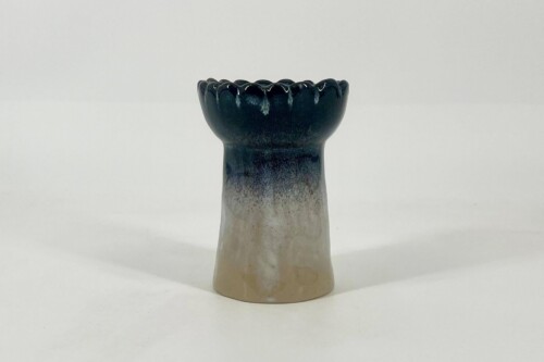 Ceramic vase neck with a scalloped, dark blue glaze fading to beige at the base.